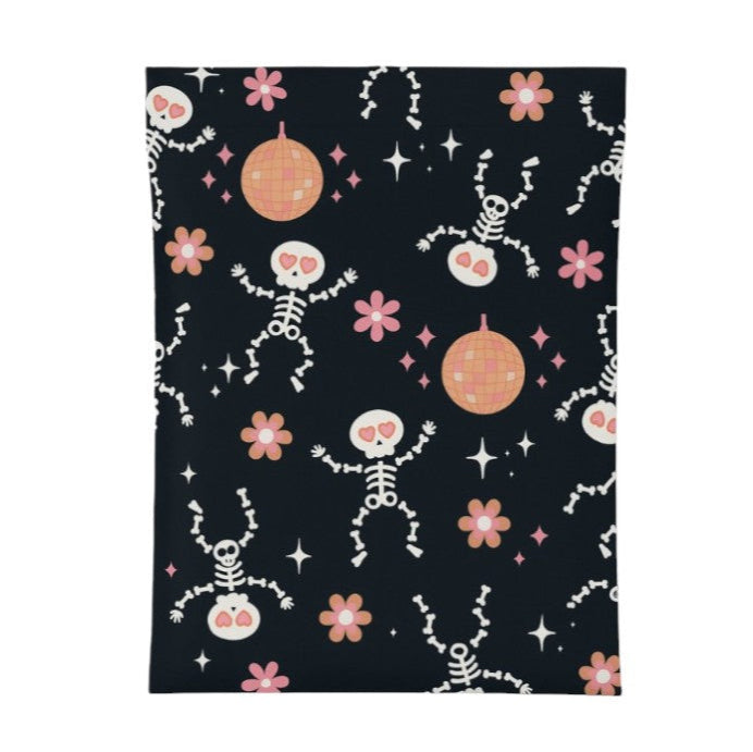 Patterned poly mailers with skeletons, flowers, and disco balls on a black background